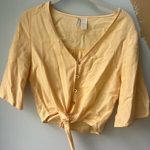 Francesca’s yellow button down blouse that also ties in the front